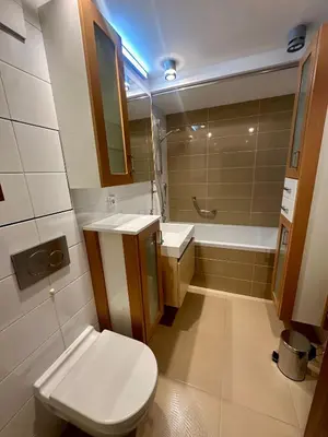 a bathroom with a toilet and a sink and a tub at Loft Ballerina in Prague