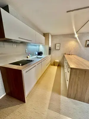 a large kitchen with white cabinets and a sink at Loft Ballerina in Prague