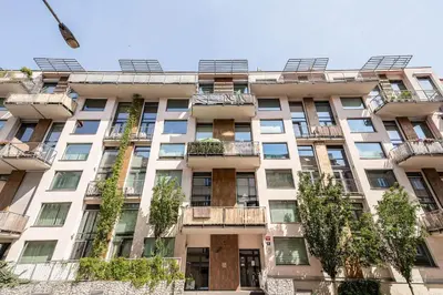 an apartment building with balconies and trees at Loft Ballerina in Prague