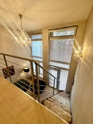 a staircase in a building with a chandelier at Loft Ballerina in Prague