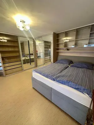 a bedroom with a large bed and some glass cabinets at Loft Ballerina in Prague