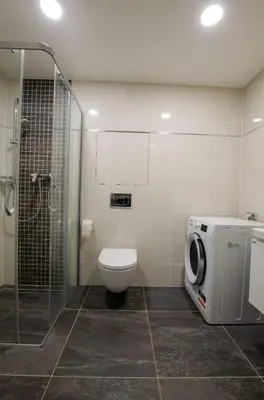 a bathroom with a toilet and a glass shower at Harmony106 in Prague