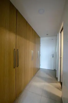 an empty hallway with wooden cabinets and a door at Harmony106 in Prague