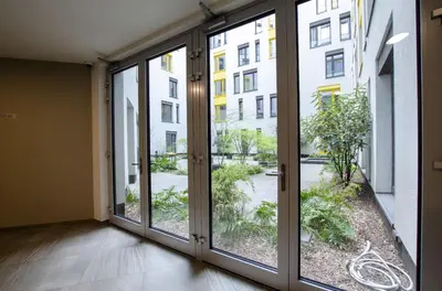 a hallway with sliding glass doors in a building at Harmony106 in Prague