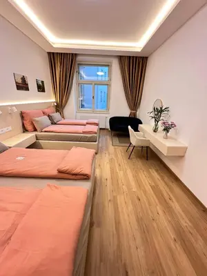 a room with three beds and a couch at Old Town Prague Apartment in Prague