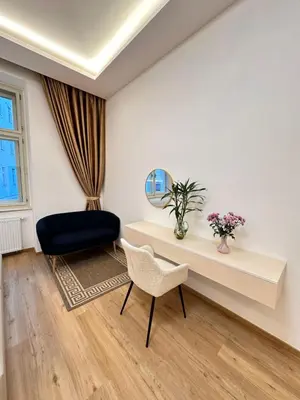 a living room with a desk and a chair at Old Town Prague Apartment in Prague