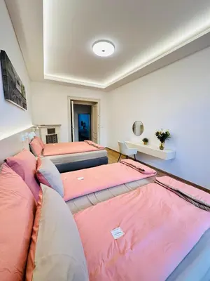 a room with three beds in a room at Old Town Prague Apartment in Prague