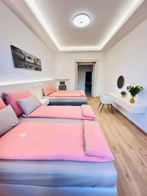 two beds in a room with pink and blue at Old Town Prague Apartment in Prague