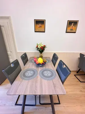 a dining room table with a bowl of fruit on it at Old Town Prague Apartment in Prague