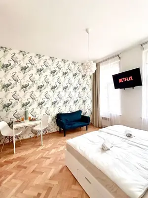a bedroom with a bed and a table and a chair at Studio Oliver in Prague