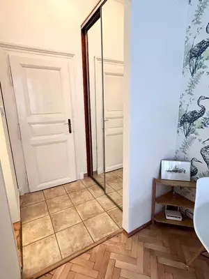 a hallway with a mirror and a door at Studio Oliver in Prague