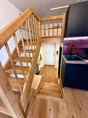 a loft conversion with a staircase and a kitchen at Apartment Divadelni - Historic Center & steps from Charles Bridge in Prague