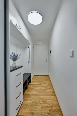 a hallway with white cabinets and a ceiling at Residence Kobrova with free parking in Prague
