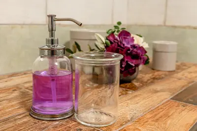 a bottle of purple liquid sitting on top of a table at Penzion Ztracený mlýn in Slapy