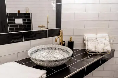 a bathroom with a large bowl sink on a counter at Penzion Ztracený mlýn in Slapy