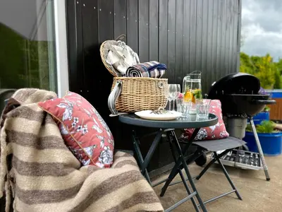 a patio with pots of plants and an umbrella at Garden Residence - The Lotus in Drahobudice