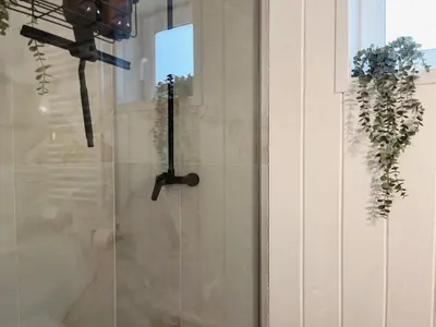 a glass door with a clock on a wall at Garden Residence - The Lotus in Drahobudice