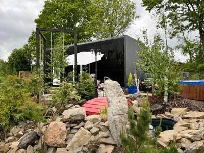 a rock garden with a statue in a yard at Garden Residence - The Lotus in Drahobudice