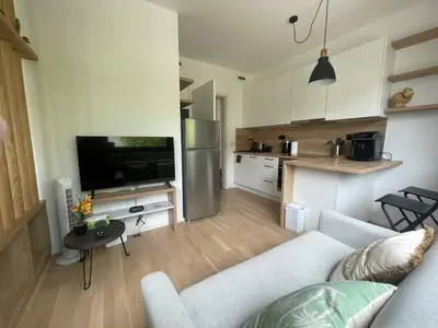 a living room with a couch and a kitchen at Vinice house in Prague