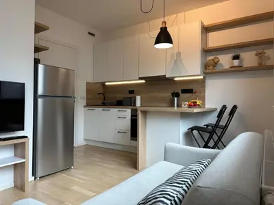 a kitchen and living room with a couch and a refrigerator at Vinice house in Prague