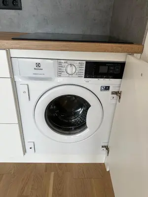 a washer and dryer in a white cabinet at Vinice house in Prague