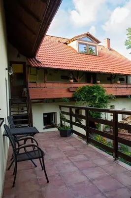 a patio with a chair and a house at Ráj za humny in Černé Voděrady