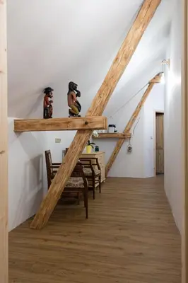 a staircase in a house with wooden beams at Ráj za humny in Černé Voděrady