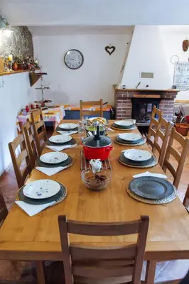a wooden table with plates and a pot on it at Ráj za humny in Černé Voděrady