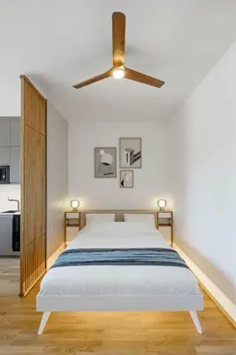 a bedroom with a bed and a ceiling fan at Urban Balance Suite, Andel in Prague