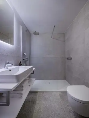 a white bathroom with a sink and a toilet at Urban Balance Suite, Andel in Prague