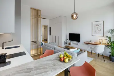 a living room with a couch and a table with a bowl of fruit at Urban Balance Suite, Andel in Prague