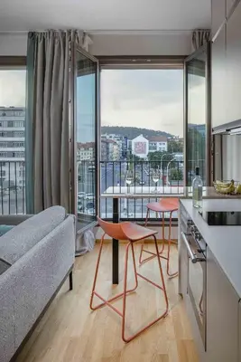 a kitchen and living room with a view of a city at Urban Balance Suite, Andel in Prague