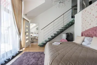a bedroom with a bed and a table and chairs at Wellness & SPA boutique Hotel pod lipkami Prague in Prague