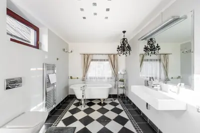 a bathroom with two sinks and a tub and a toilet at Wellness & SPA boutique Hotel pod lipkami Prague in Prague