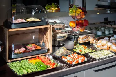a buffet filled with lots of different types of food at Wellness & SPA boutique Hotel pod lipkami Prague in Prague