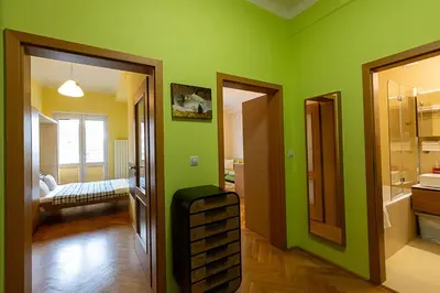 a room with green walls and a room with a bathroom at Sunny apartment in Prague