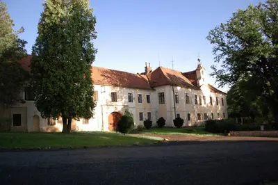 a large white building with a red roof at Apartment at Château Domoušice in Domoušíce