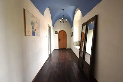 a hallway with white walls and a wooden door at Apartment at Château Domoušice in Domoušíce