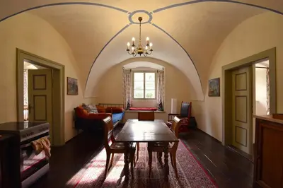 a living room with a table and a couch at Apartment at Château Domoušice in Domoušíce