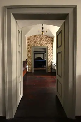 an open doorway to a room with a fireplace at Apartment at Château Domoušice in Domoušíce