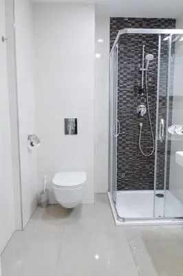 a bathroom with a shower and a toilet and a sink at HOMELY l 5 min to Airport Express,Train Station with self check in in Prague