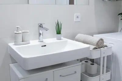 a white bathroom with a sink and a toilet at HOMELY l 5 min to Airport Express,Train Station with self check in in Prague