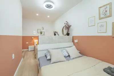a bedroom with a large bed with two pillows at HOMELY l 5 min to Airport Express,Train Station with self check in in Prague