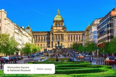 a large building with a clock tower in a city at HOMELY I 50m2 central APT I ELEVATORI Park & Museum View in Prague