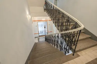 a stairway with a wrought iron railing at HOMELY I 50m2 central APT I ELEVATORI Park & Museum View in Prague