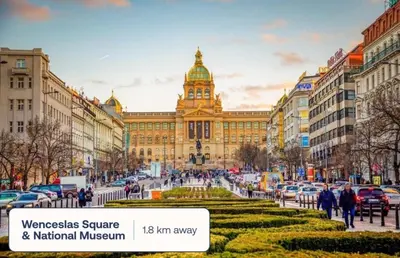 a large building with a clock tower in a city at Modern studio with terrace in Prague