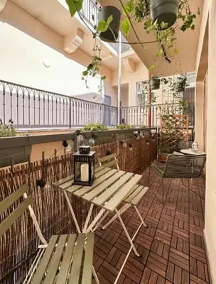 a patio with benches and tables on a balcony at Modern studio with terrace in Prague