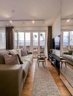 a living room with a couch and a television at Modern studio with terrace in Prague
