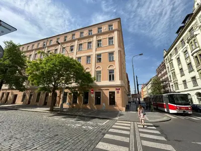 a girl crossing a street in front of a building at Modern studio with terrace in Prague