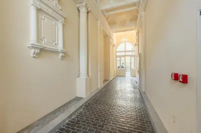 an empty hallway of a building with a brick floor at HOMELY I Central 44m2 APT I ELEVATOR I Self Check-In in Prague